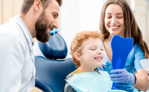 Young child in dental chair smiling