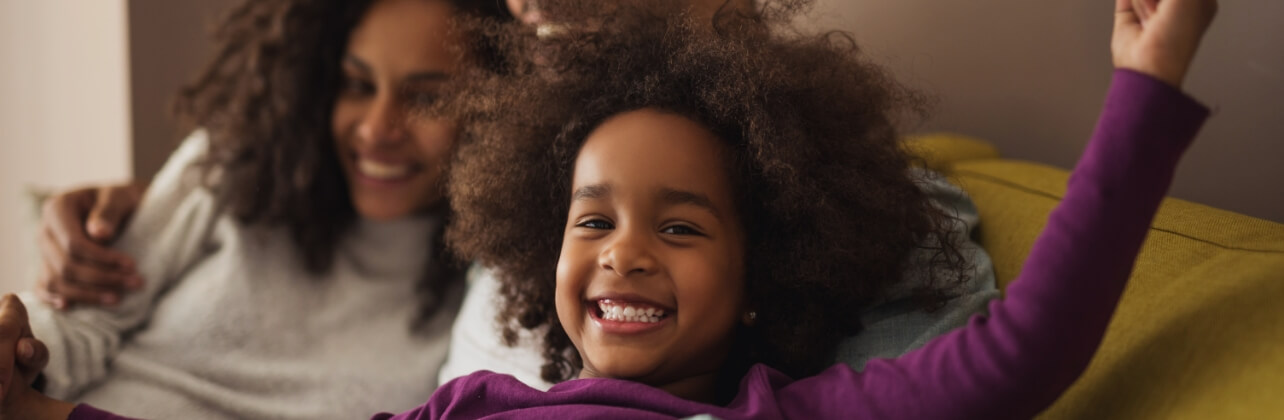 Mother and daughter with healthy smiles laughing together