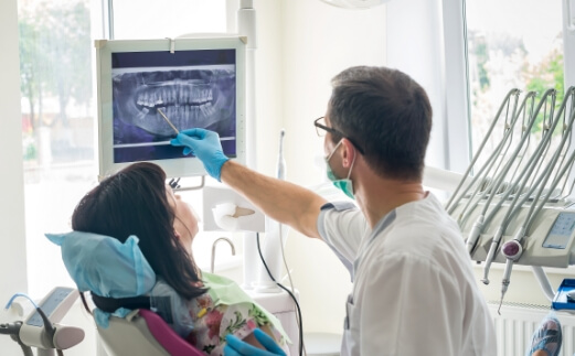 Dentist and patient looking at all digital x-rays