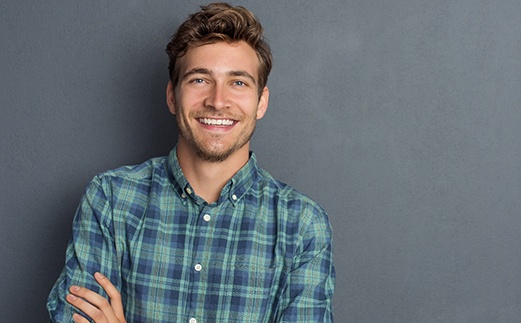 a man in Monroe smiling with dental bridges