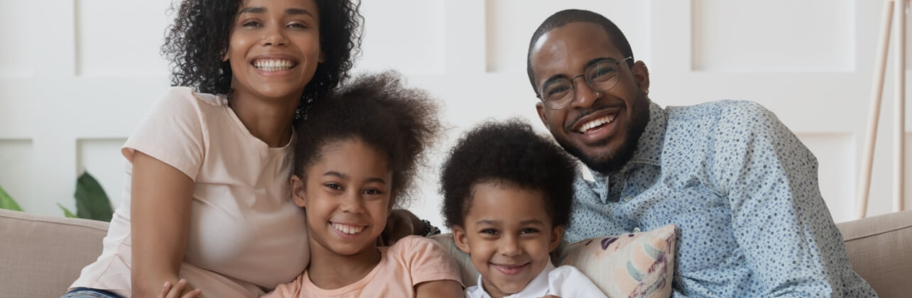 Parents and children smiling after preventive dentistry