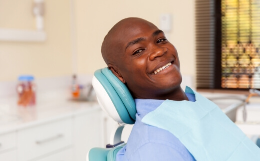 Man smiling during dental checkup and teeth cleaning visit