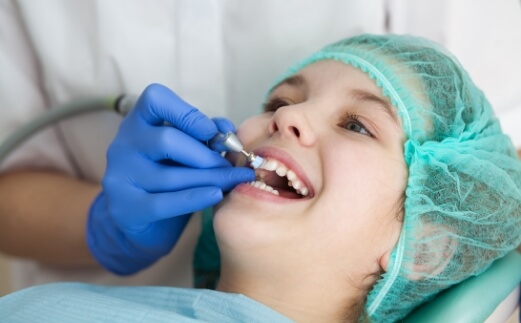 Young dental patient receiving fluoride treatment