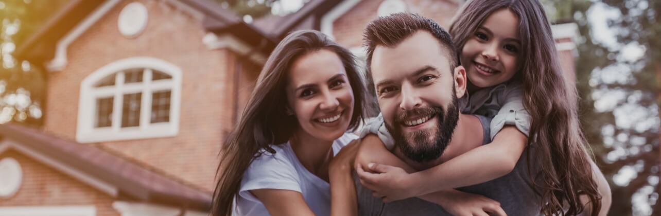 Parents and child smiling together after children's dentistry