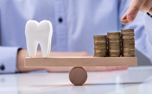 Tooth balanced with a pile of coins