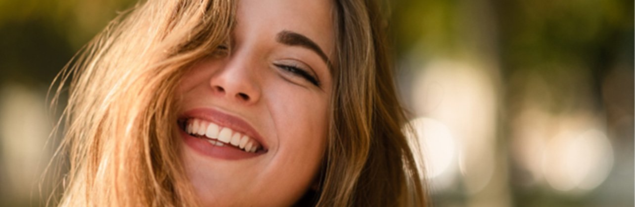 patient smiling after getting dental crown in Monroe