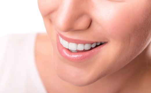 closeup of person smiling after getting dental crown in Monroe