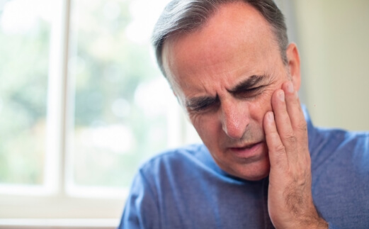 Man in pain before emergency dentistry