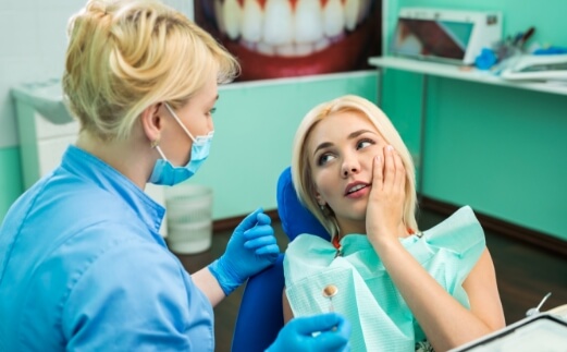 Woman visiting dentist to prevent dental emergencies
