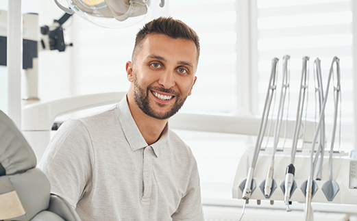 Male dental patient smiling after receiving dental implants in Monroe, LA