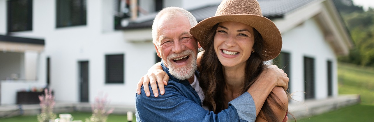 Father and daughter smiling after tooth replacement with dental implants