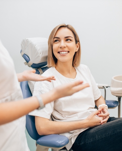Woman smiling in dental office during first visit