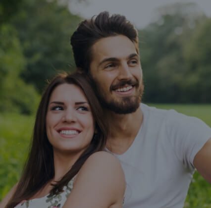 Man and woman with healthy smiles thanks to preventive dentistry