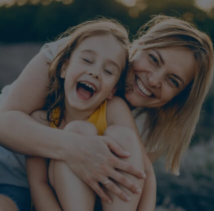 Mother and child smiling together after children's dentistry