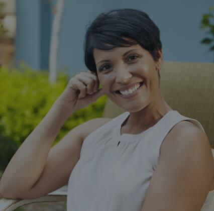 Woman with goregous smile after replacing missing teeth