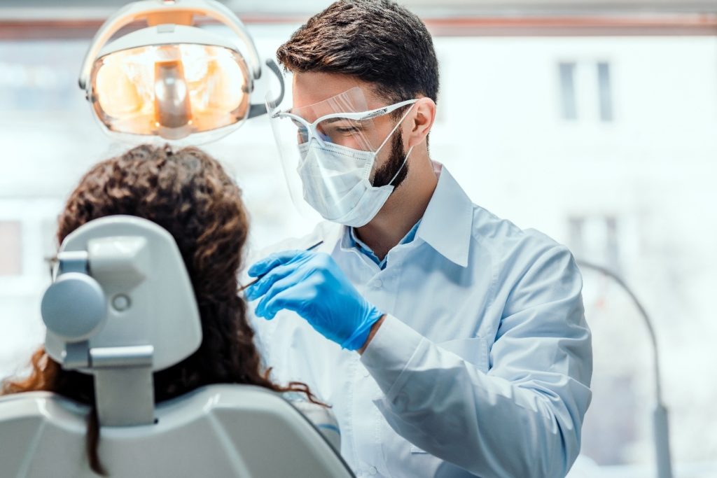 person having a dental crown replaced
