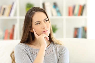 person wondering if it hurts to get a dental crown