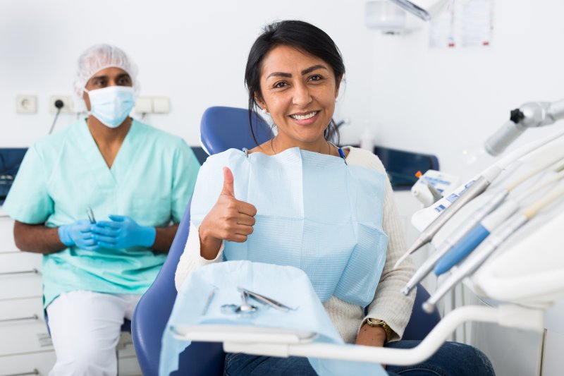 Patient smiling after having dental filling replaced